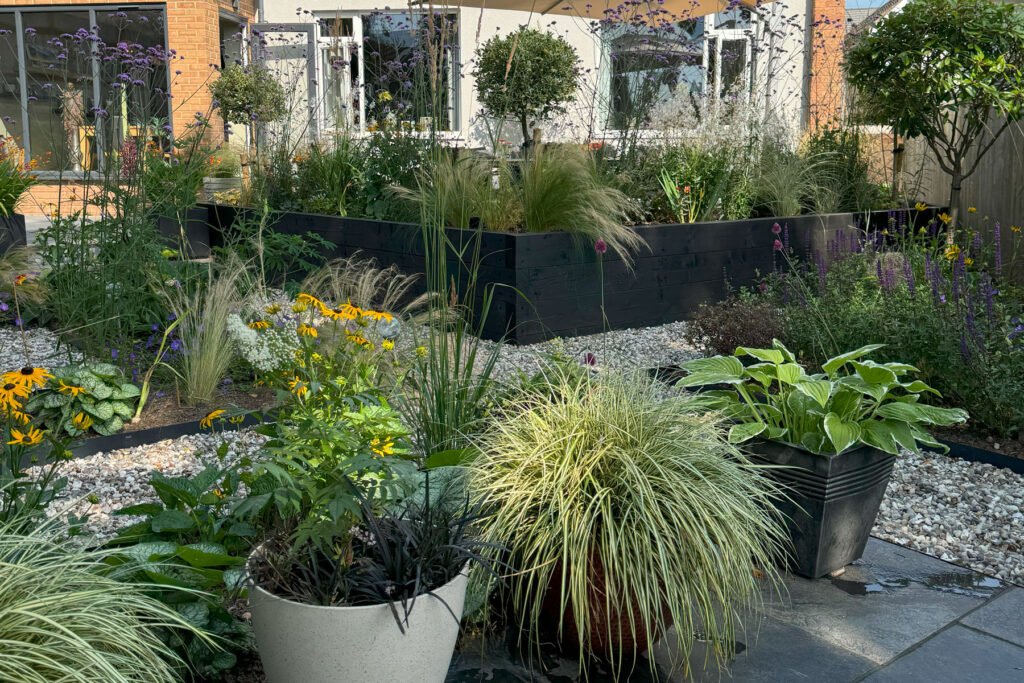 Small garden utilising perspective with diagonal and angled pathways and paving to help make the space feel longer. 